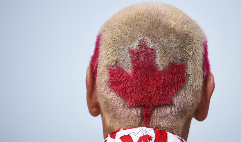 ST ANDREWS, SCOTLAND - JULY 16: A fans sports  a Canadian flag hairstyle as he follows Graham Delaet of Canada during the first round of the 144th Open Championship at The Old Course on July 16, 2015 in St Andrews, Scotland.  (Photo by Stuart Franklin/Getty Images)