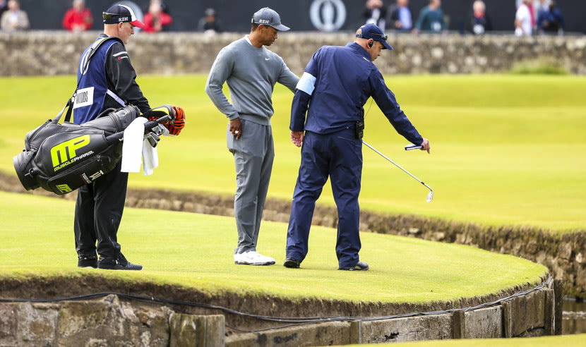 ST ANDREWS, SCOTLAND - JULY 16: Tiger Woods of the United States assesses his ball on the 1st hole after hitting into the brook during the first round of the 144th Open Championship at The Old Course on July 16, 2015 in St Andrews, Scotland.  (Photo by Andrew Redington/Getty Images)