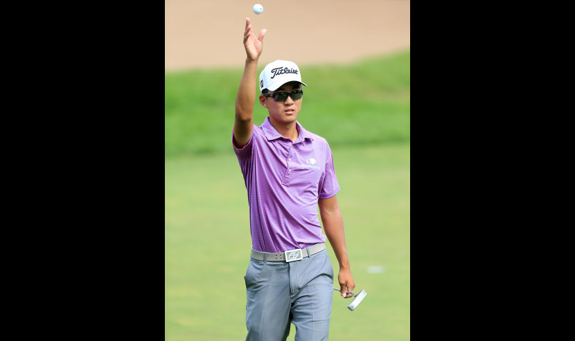 OAKVILLE, ON - JULY 21:  Michael Kim tosses his ball to his caddy after sinking his put on the fifth hole during the first round of the RBC Canadian Open at Glen Abbey Golf Club on July 21, 2016 in Oakville, Canada.  (Photo by Vaughn Ridley/Getty Images)