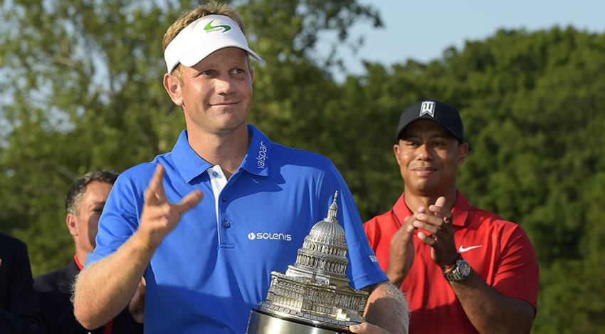 Billy Hurley with trophy while Tiger applauds