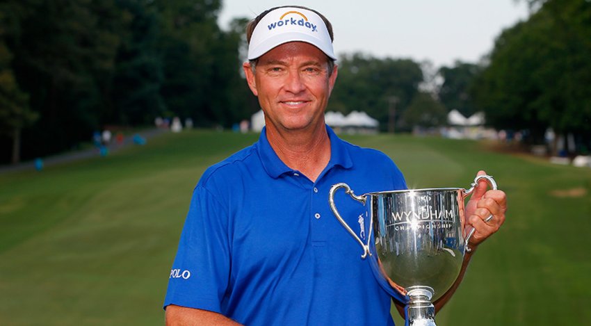 Davis Love III holds the Sam Snead Trophy